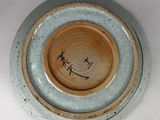 a blue and brown bowl with writing on it