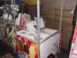 a food cart that has a lot of food inside of it