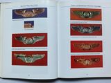 an open book with a picture of a number of wings on it