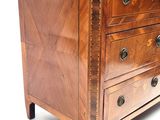 a wooden chest of drawers with a marble top