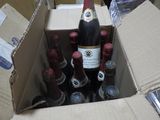 many bottles of wine in a cardboard box on the floor