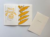 an open book with a drawing of a banana on it