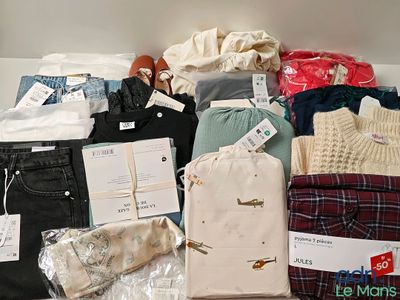 a lot of clothes that are sitting on a table