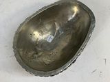 an old silver spoon sitting on top of a white table