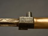 close up of a metal pipe with a brass handle and a piece of metal