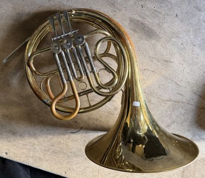 a brass french horn sitting on top of a table