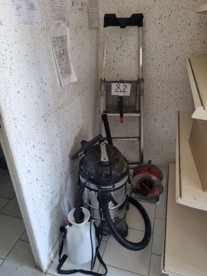 a picture of a room with a vacuum and a ladder
