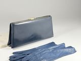 blue leather gloves and a blue purse on a white surface