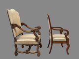 pair of carved wood chairs with upholstered arms and arms