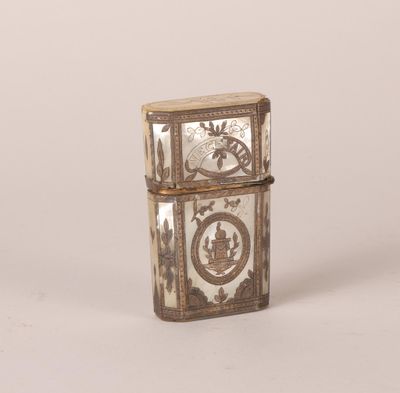 an old silver lighter with a clock on it sitting on a white surface