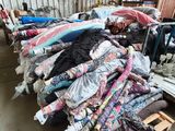 a pile of clothes on a pallet in a warehouse