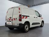 a white van with red stripes parked in a garage