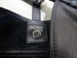 a close up of a purse with a tag on it