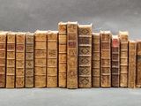 several old books stacked on top of each other on a table