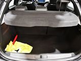 the trunk of a car with a mop and a broom in it