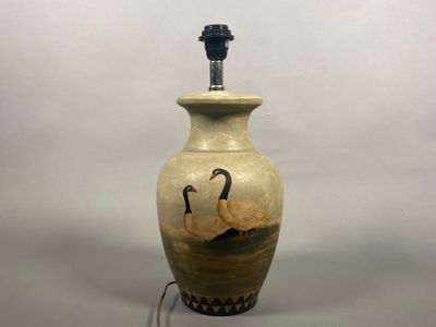 a lamp that is sitting on a table next to a white wall
