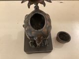 a vase with a bird on top of it on a table