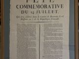 an old newspaper is hanging on a wall in a room