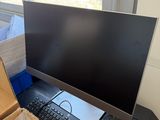 an image of a computer monitor and keyboard on a desk
