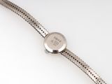 an image of a close up of a wrist watch on a white surface