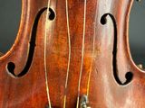 close up of a violin ' s bow and strings with a black background