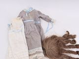a doll that is laying on the ground next to a pair of shoes