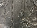 an image of a metal plaque with a lady and a cat