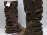 pair of brown leather boots with zippers on the side of them