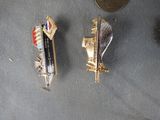 two pins that are sitting on a table