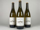three bottles of wine sitting next to each other on a table