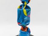 a close up of a blue sculpture on a black base