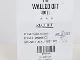 a ticket for the walled off hotel on the table