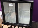 a black refrigerator with a glass door and a box of wine