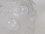 a clear glass vase with a decorative design on it