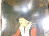 un tableau représentant un homme assis à une table dans une pièce