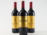 three bottles of wine sitting on top of a white surface