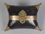 a black and gold box with a gold decoration