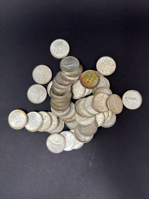 a pile of coins sitting on a black surface