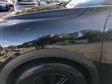 a black car parked on the side of the street