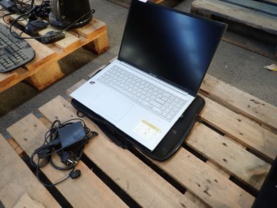 a laptop computer sitting on a pallet next to a keyboard