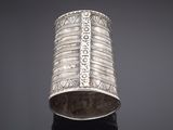 an old silver bracelet with a design on it