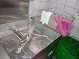 a sink in a kitchen with a towel hanging out of it ' s side