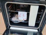 a black and white oven with a sign on the door