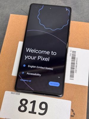 the back of a black samsung phone sitting on top of a cardboard box