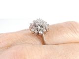 an image of a woman ' s hand holding a diamond ring