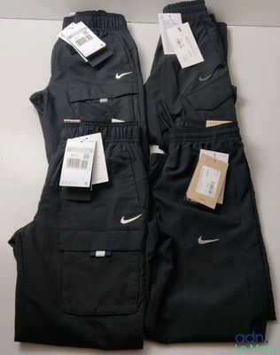 a pair of black pants with tags on them sitting on a table