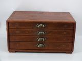an image of a small wooden chest of drawers with five drawers