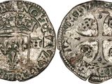 a silver coin with a cross on the front and a cross on the back