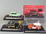 four different models of cars on display in a display case