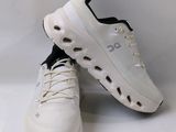white sneakers with holes on the soles of them on a white background
